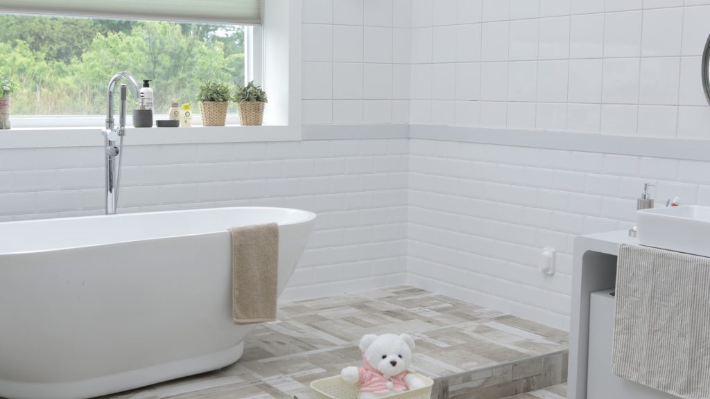 DIY Bathroom Repairs | Powell Realtors (showing a tiled bathroom with soaker tub)