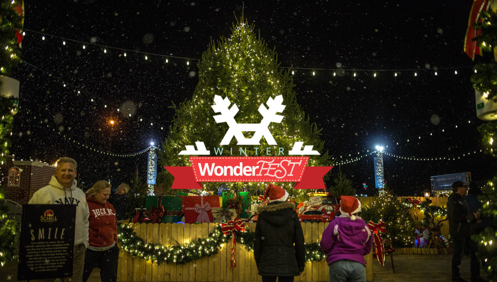 Christmas tree with people celebrating outside at WonderFest